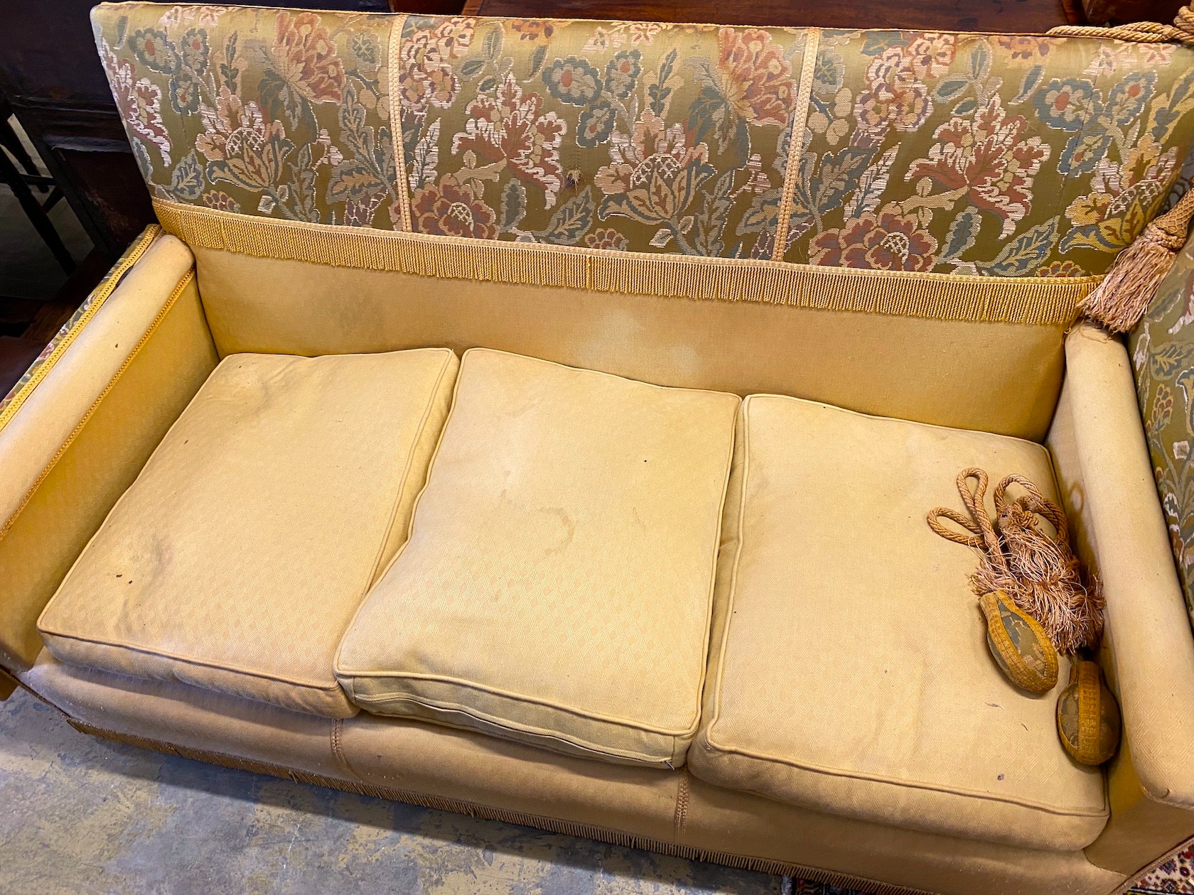 A Knole settee, upholstered in floral brocade, width 186cm, depth 80cm, height 104cm.